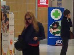 Photo of Justine Sacco in airport holding her phone up to her ear.